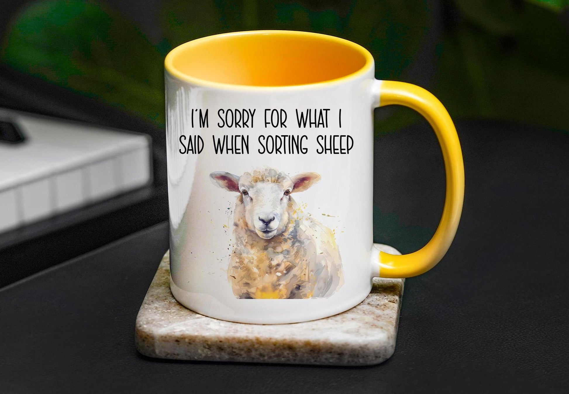 A detailed white sheep with shades of yellow and light greys, on a white mug with a golden yellow handled and inside. Black text reads 'I'm sorry for what I said when sorting sheep'